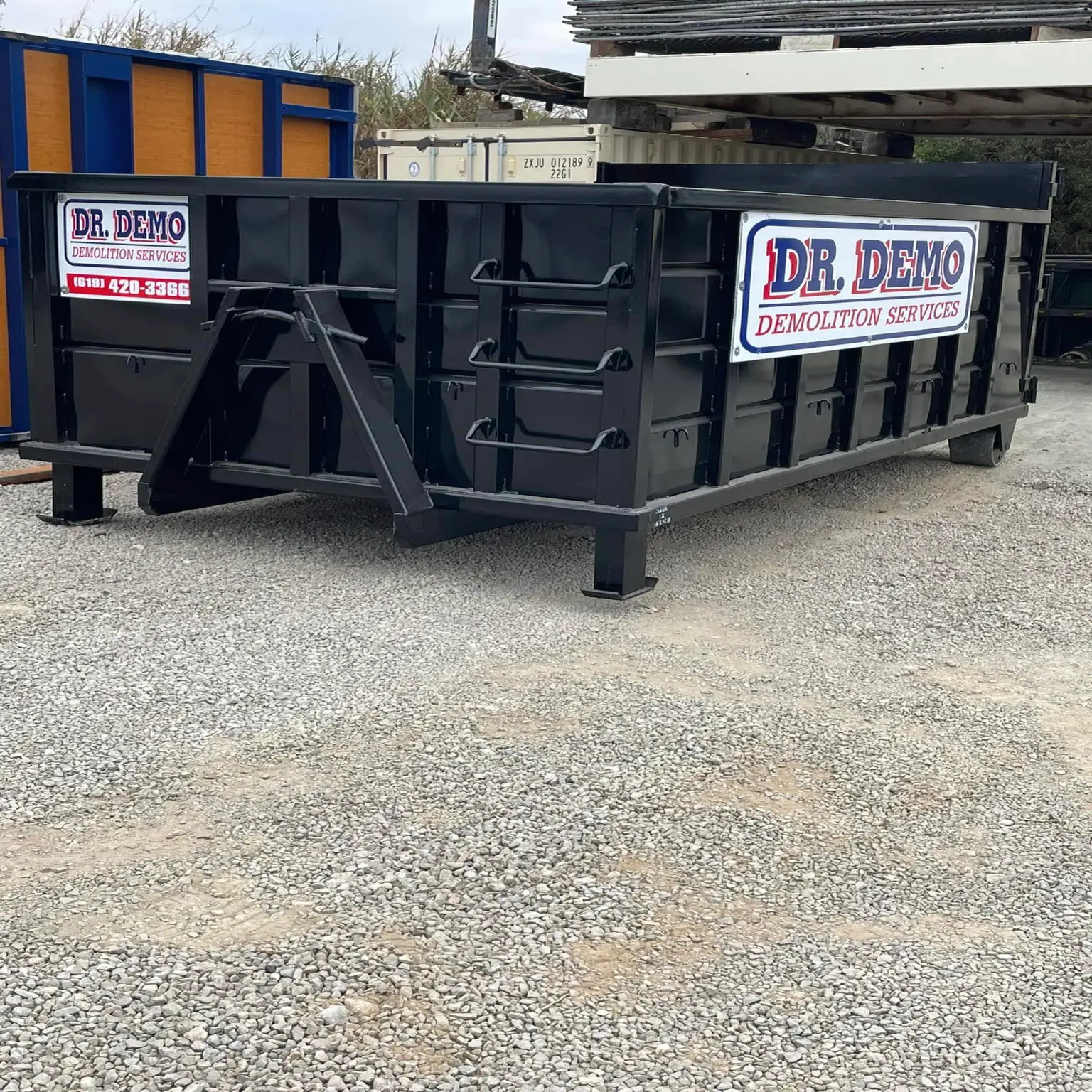 Dr Demo Dumpsters delivery truck with 15 yard dumpster ready for drop off